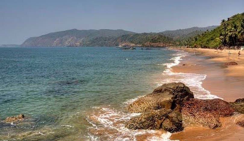 Wide sand and gentle surf on a South Goa beach